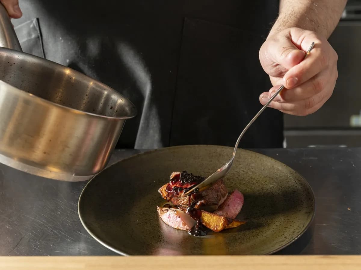 A chef plating a dish at Airodokoro