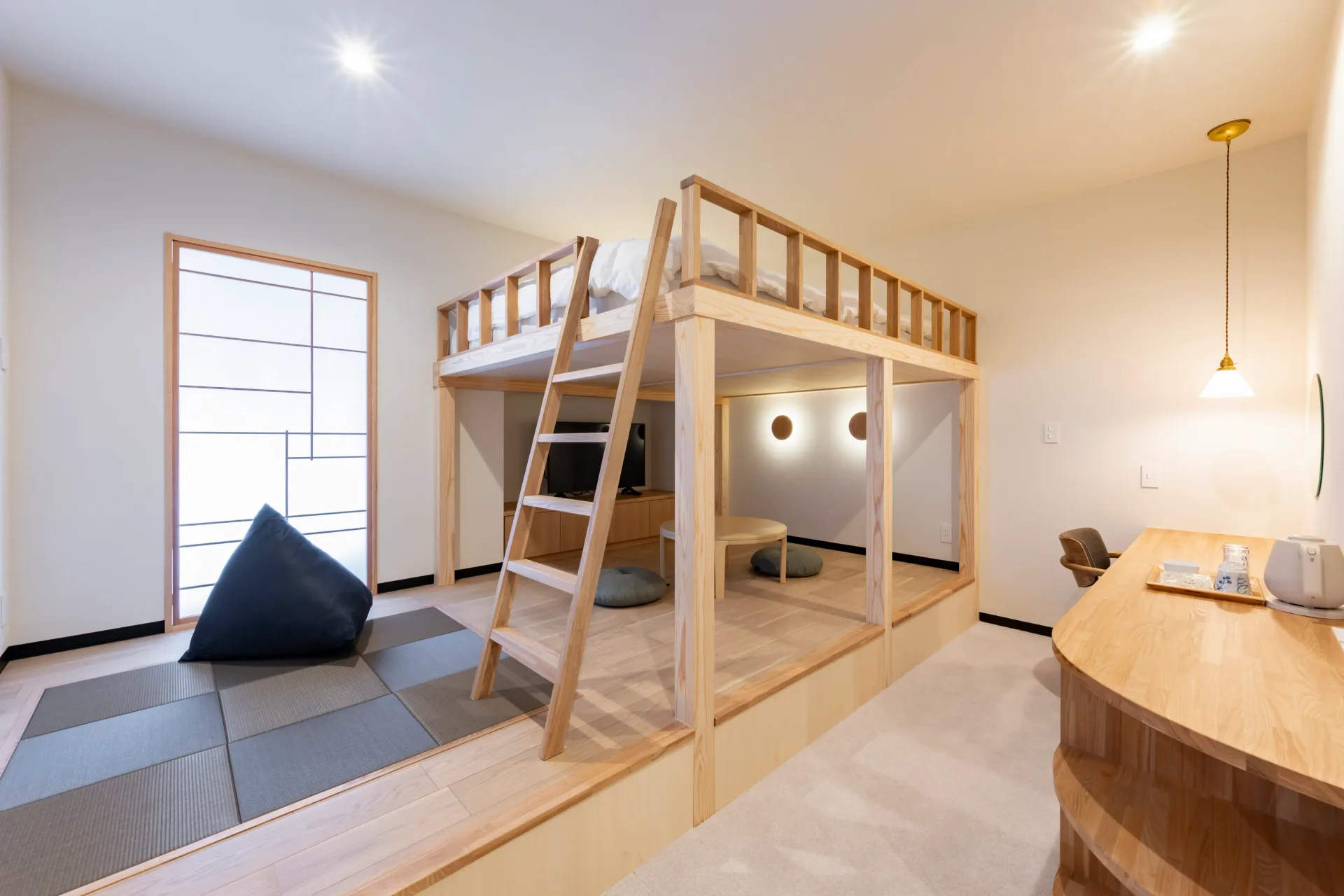 Standard room 105, a ladder-access loft bed beside a tatami corner lit through shoji screens